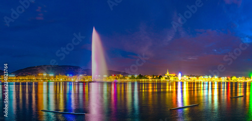 Sunset view of Geneva dominated by Jet d'eau fountain and Saint Pierre Cathedral, Switzerland