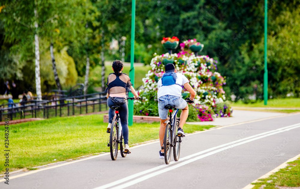 Cyclists ride on the bike path in the city Park 