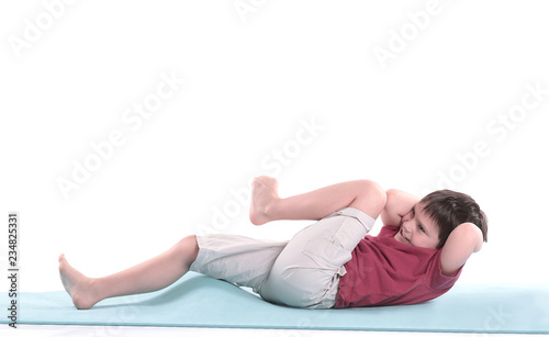 little boy performs an exercise for the press.isolated on white