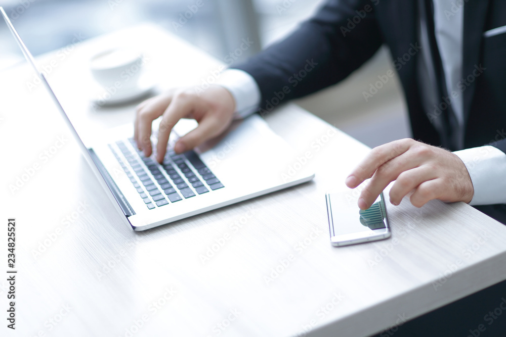 close up.modern businessman typing on laptop. photo with copy space. close up.modern businessman typing on laptop. photo with copy space.
