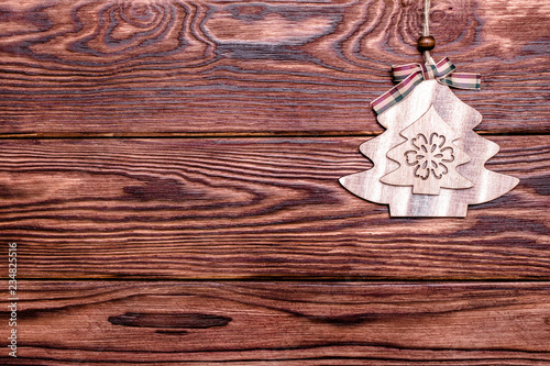 Christmas toy lies on a brown wooden background 
