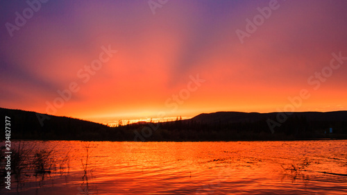 Rays of the setting sun over the lake