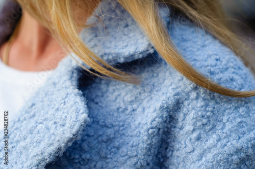 Woman - blonde in a coat of blue faux fur, lapel - close-up