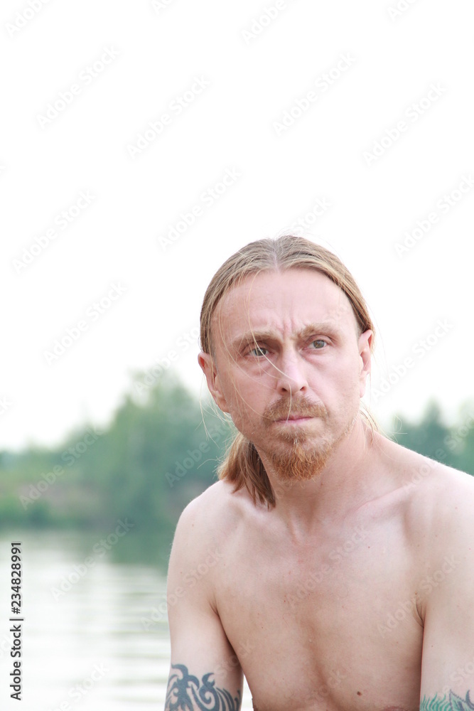 Russian man with a red beard in a boat Russian man with a red beard in a boat