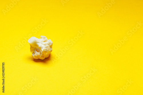 Cauliflower pieces on a bright yellow background