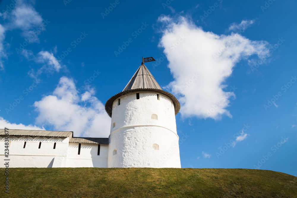 View of white tower on the hill and blue sky with white clouds background
