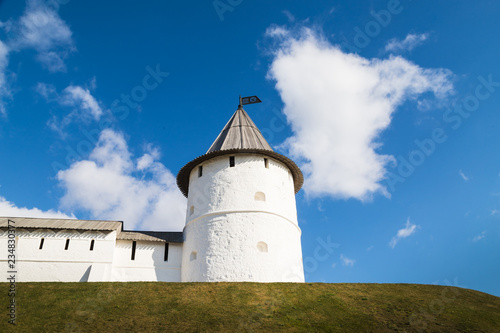 View of white tower on the hill and blue sky with white clouds background