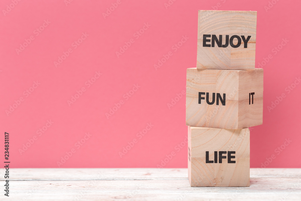 Wooden cubes with text on table over pink background with copy space for text Wooden cubes with text on table over pink background with copy space for text