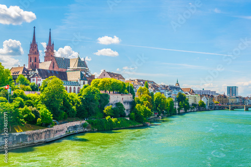 Riverside of Rhine in Basel dominated by majestic building of Munster church, Switzerland