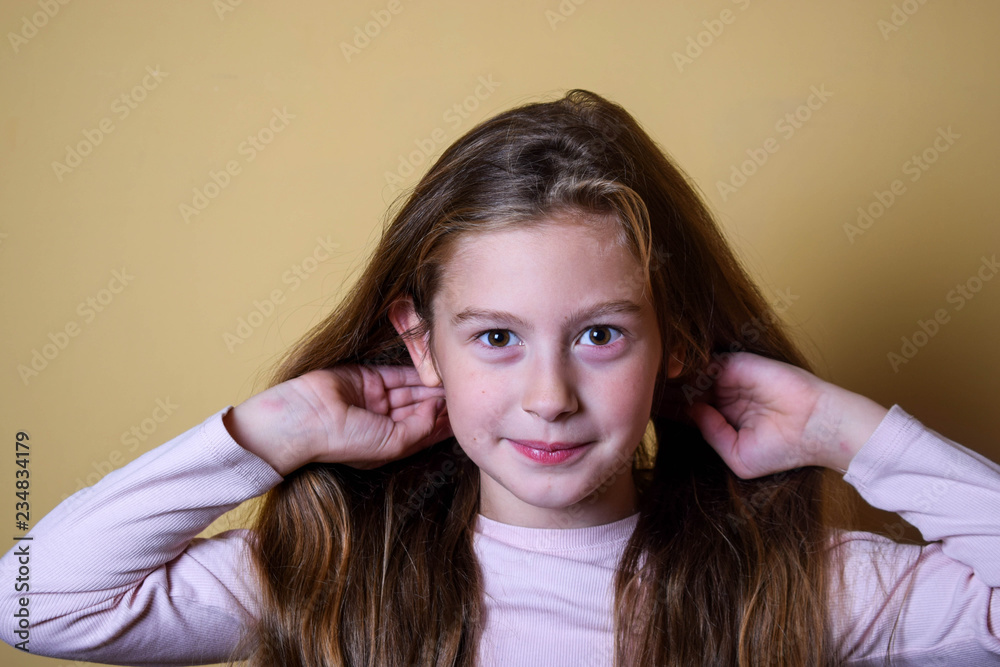 Portrait of little pretty girl make an air kiss. Beautiful girl with long  dark blonde hair and wonderful expressive brown eyes. Little lady  schoolgirl Stock Photo - Alamy