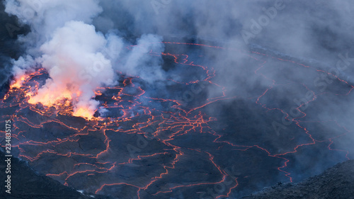 Molten magma red hot lava flowing on cold lavafiled in grey colored texture of volcanic background. Nyiragongo Volcano. RD Congo