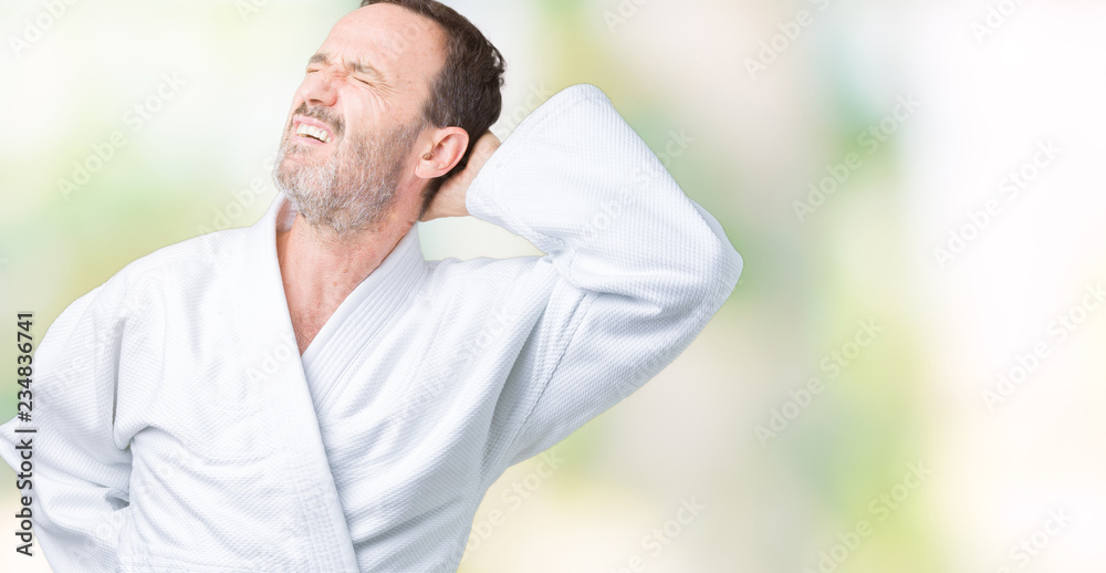 Handsome middle age senior man wearing kimono uniform over isolated background Suffering of neck ache injury, touching neck with hand, muscular pain Handsome middle age senior man wearing kimono uniform over isolated background Suffering of neck ache injury, touching neck with hand, muscular pain