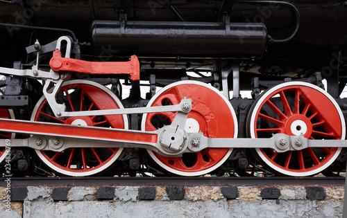 red and white wheels of the old classic steam locomotive, side view