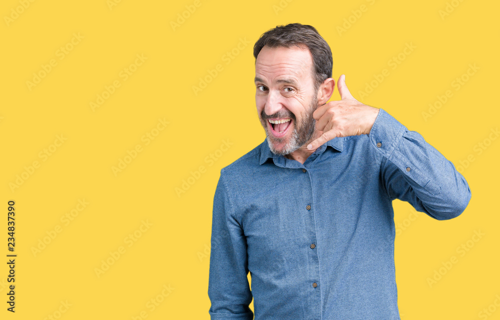 Handsome middle age elegant senior man over isolated background smiling doing phone gesture with hand and fingers like talking on the telephone. Communicating concepts. Handsome middle age elegant senior man over isolated background smiling doing phone gesture with hand and fingers like talking on the telephone. Communicating concepts.