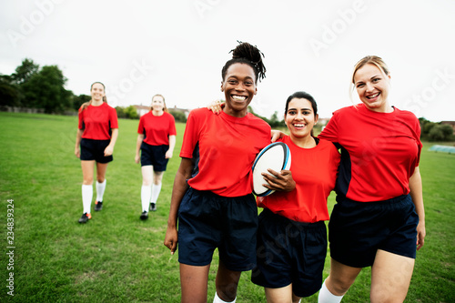 Energetic female rugby players walking together