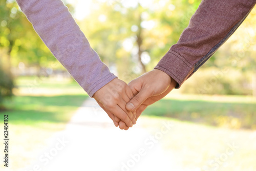 Young couple holding hands outdoors