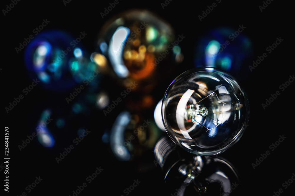Retro light bulb with reflection on black table Retro light bulb with reflection on black table