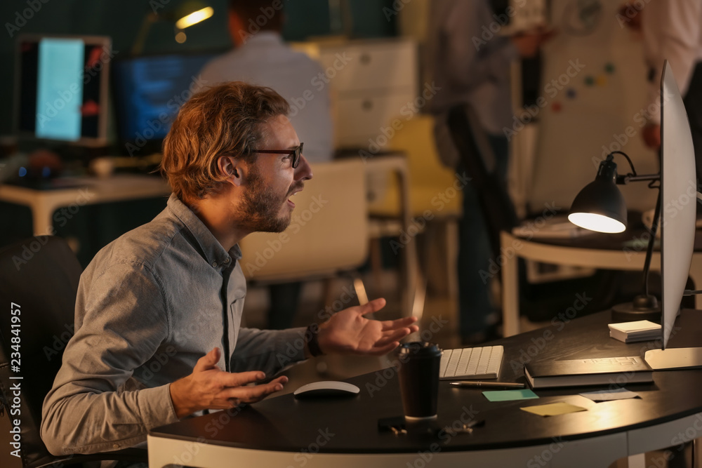 Stressed IT specialist trying to meet deadline in office Stressed IT specialist trying to meet deadline in office