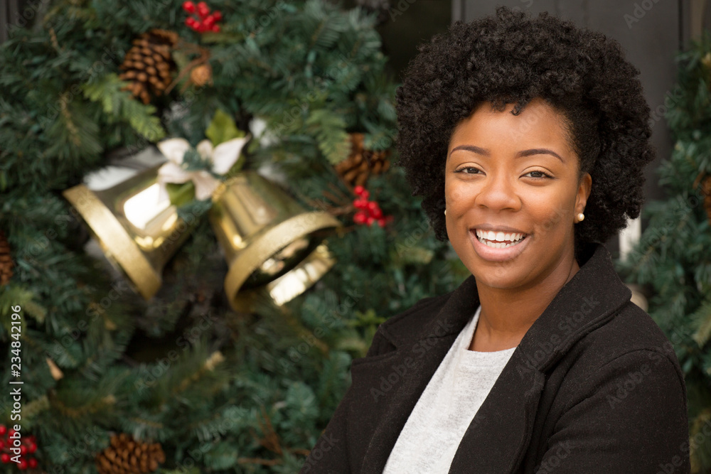 African American woman smiling outside at Christmas. African American woman smiling outside at Christmas.