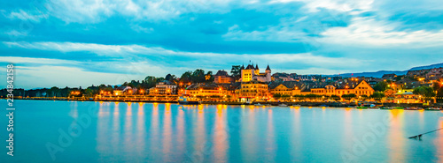Sunset view of a white Palace in Nyon overlooking the Geneva lake in Switzerland