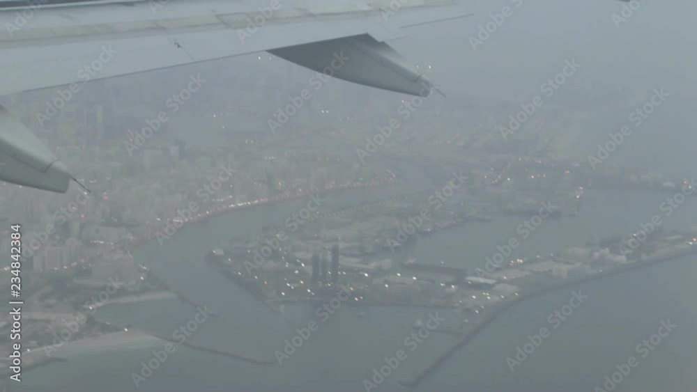 Aerial cityscape of Sharjah,UAE.Looking at skyscrapers and from flying airplane Aerial cityscape of Sharjah,UAE.Looking at skyscrapers and from flying airplane