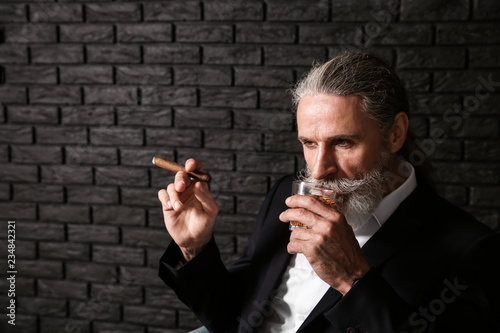 Senior man drinking whiskey...