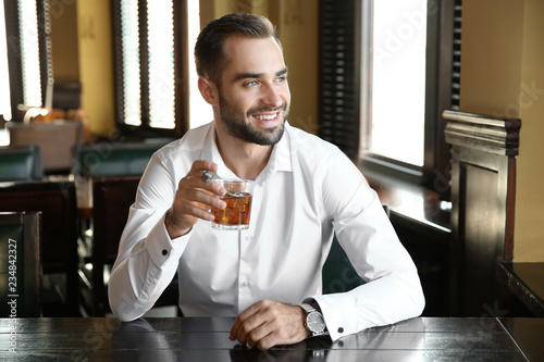 Young man with glass of whi...