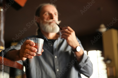 Senior man with glass of wh...