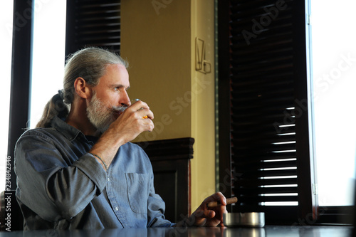 Senior man drinking whiskey...