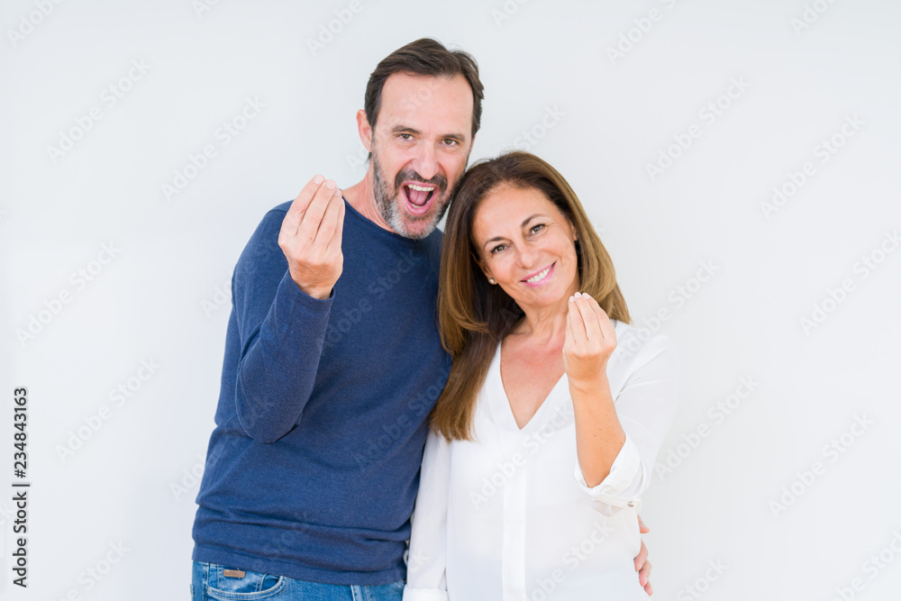 Beautiful middle age couple in love over isolated background Doing Italian gesture with hand and fingers confident expression Beautiful middle age couple in love over isolated background Doing Italian gesture with hand and fingers confident expression