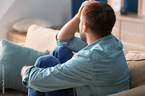 Lonely depressed man at home