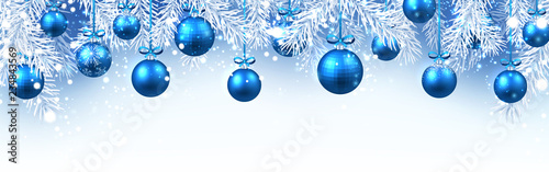 Christmas and New Year banner with fir branches and blue Christmas balls.