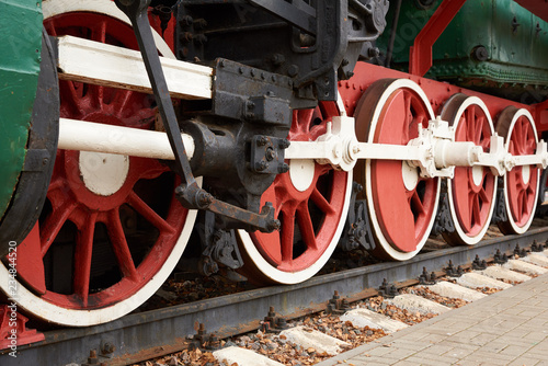 red and white wheels of the old steam locomotive, close up view