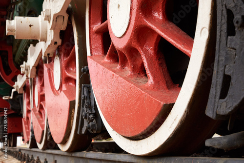 red and white wheels of the old steam locomotive, close up view