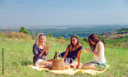 Young woman having picnic in summer day.