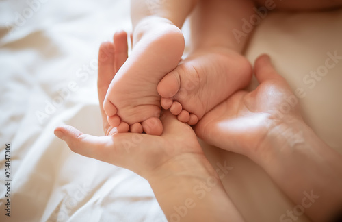 Baby legs in mother's hands