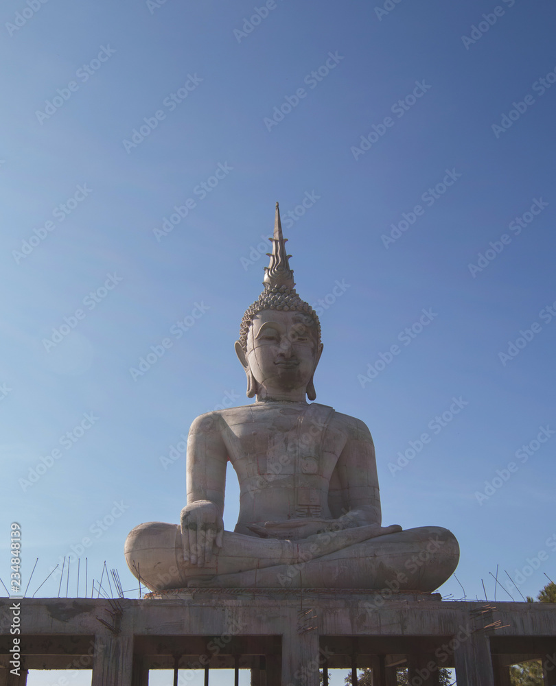 Buddha statue building outdoor in Thailand's temple on blue sky background Buddha statue building outdoor in Thailand's temple on blue sky background