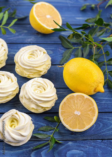 Yellow  apple marshmallow with lemon on a bright blue background.