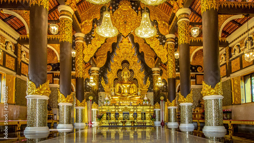 Golden Buddha in a magnificent church   at Wat Prathat Doi Prachan, Lampang Thailand NOV 18 2018 photo