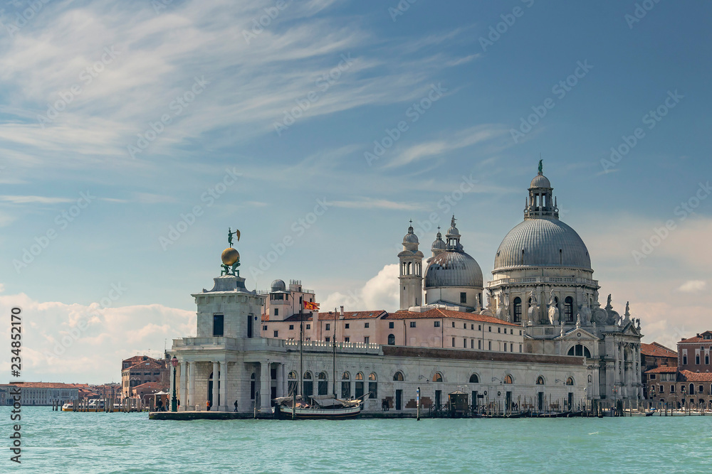 view from the Grand Canal to the Cathedral of Santa Maria della Salute on a beautiful blue sky background