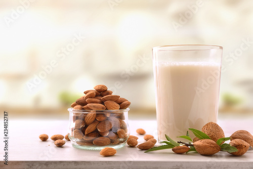 Alternative milk of almonds on white table in kitchen detail