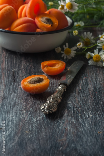 Fresh organic apricots on rustic wooden background.