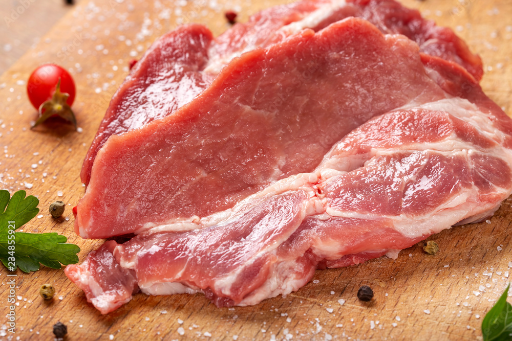 Slices of raw pork meat with herbs Slices of raw pork meat with herbs