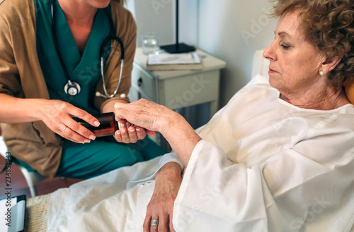 Female doctor giving medication dose to elderly patient