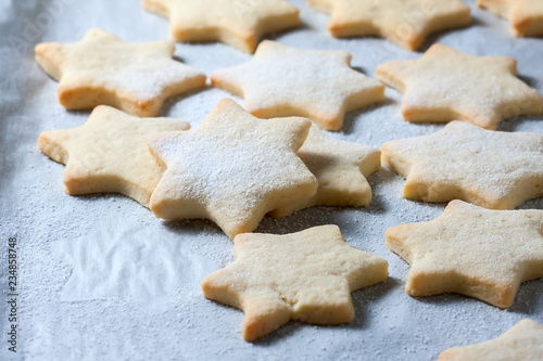 Homemade star shaped cookies on a wooden background. Christmas decoration