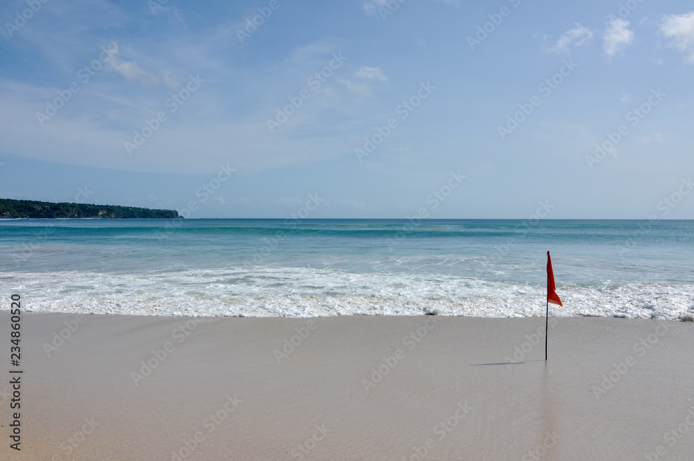 beach with a red flag 