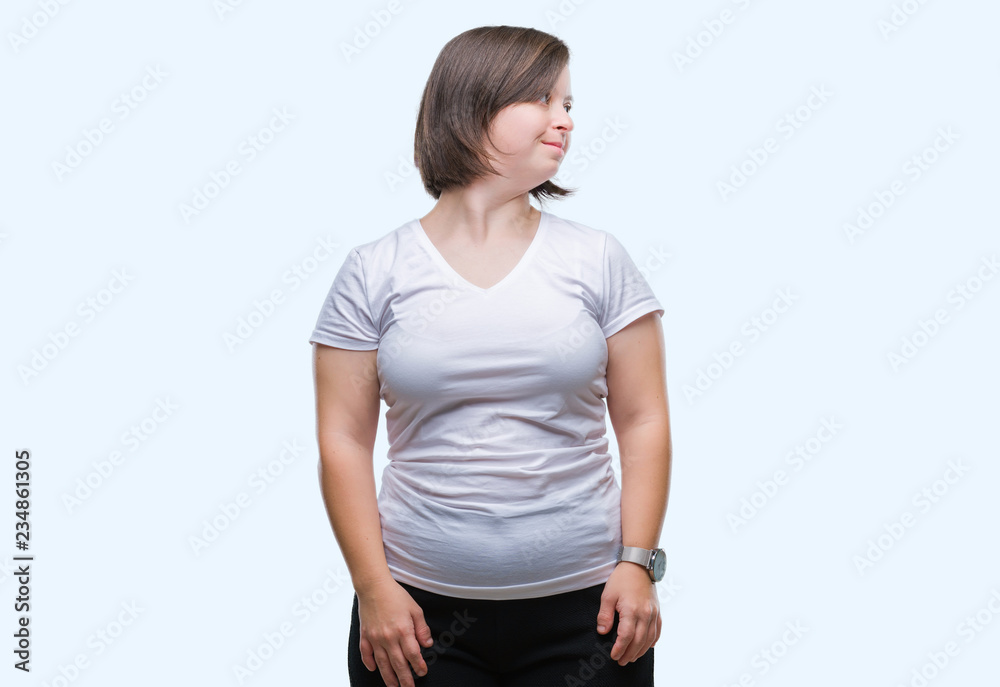Young adult woman with down syndrome over isolated background looking away to side with smile on face, natural expression. Laughing confident. Young adult woman with down syndrome over isolated background looking away to side with smile on face, natural expression. Laughing confident.
