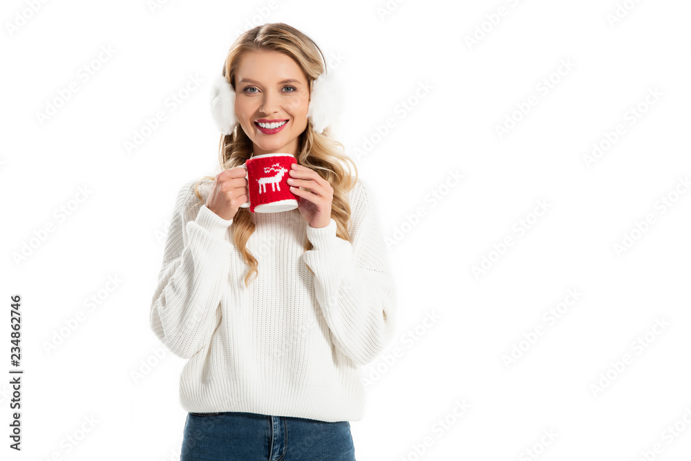 attractive smiling girl in winter earmuffs holding cup with hot coffee isolated on white attractive smiling girl in winter earmuffs holding cup with hot coffee isolated on white