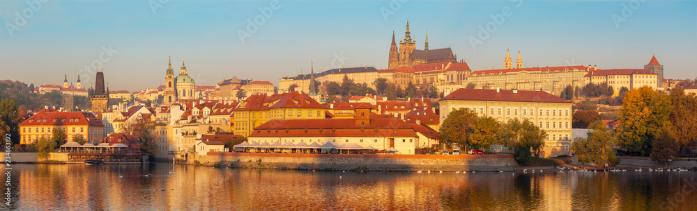 Prague - The cityscape panorama of the Town, Castle and Cathedral from promenade over the  Vltava river in the morning light.