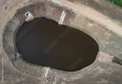 Neugebautes, modernes Regenrückhaltebecken im Industriegebiet, Luftbild photo
